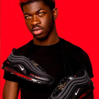 Lil Nas X is stepping out to collaborate with New York-based art collective MSCHF, and footwear powerhouse Nike is seeing red. The out singer and rapper is launching limited-edition satan shoes — unofficially modified Nike Air Max 97s that feature a pentagram, inverted cross and a drop of human blood. Nike released a statement to CNN, declaring, "We do not have a relationship with Lil Nas or MSCHF. Nike did not design or release these shoes and we do not endorse them." Only 666 pairs of shoes were manufactured and will be sold for the biblical price of $1,018, referencing Luke 10:18, which reads, "I saw Satan fall like lightning from heaven." Lil Nas spun the controversy into a promotional opportunity, releasing a new YouTube video to his 12.1 million subscribers titled "Lil Nas X Apologizes for Satan Shoe," only to show several seconds of the singer posing with the shoe followed by a quick cut to his latest music video, "Montero (Call Me By Your Name)." Tap link in bio to continue on @EDGEmedianetwork ?️‍??? (?: Lil Nas X / Satan.Shoes / Website)