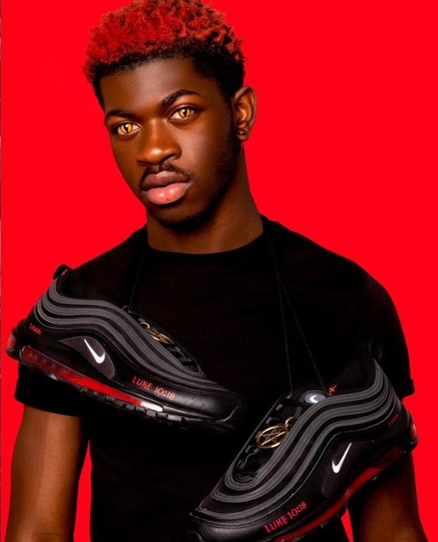 Lil Nas X is stepping out to collaborate with New York-based art collective MSCHF, and footwear powerhouse Nike is seeing red. The out singer and rapper is launching limited-edition satan shoes — unofficially modified Nike Air Max 97s that feature a pentagram, inverted cross and a drop of human blood. Nike released a statement to CNN, declaring, "We do not have a relationship with Lil Nas or MSCHF. Nike did not design or release these shoes and we do not endorse them." Only 666 pairs of shoes were manufactured and will be sold for the biblical price of $1,018, referencing Luke 10:18, which reads, "I saw Satan fall like lightning from heaven." Lil Nas spun the controversy into a promotional opportunity, releasing a new YouTube video to his 12.1 million subscribers titled "Lil Nas X Apologizes for Satan Shoe," only to show several seconds of the singer posing with the shoe followed by a quick cut to his latest music video, "Montero (Call Me By Your Name)." Tap link in bio to continue on @EDGEmedianetwork ?️‍??? (?: Lil Nas X / Satan.Shoes / Website)