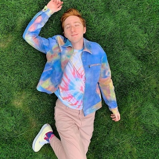 On Disney+'s "High School Musical: The Musical: The Series," Larry Saperstein plays Big Red, a character who has a relationship with a female student named Ashlyn Caswell (Julia Lester). But in real life, Saperstein took to TikTok to announce he is bisexual, according to People. In the TikTok, Saperstein is seen in a close-up selfie with the words "Plays a character with a girlfriend on TV... is bi irl" appearing in subtitles as the song "International Super Spy" from the children's show "The Backyardigans" plays in the background. "Is it really that unexpected tho #pride," the 23-year-old actor captioned the post. He also promised in a tweet that he plans to get his drag game up and running before the end of the month, writing: "I have T minus 30 days to figure out how to do drag so I can turn out a look before the end of the month (#HappyPrideMonth I love you ALL SO MUCH." Tap link in bio to continue on @EDGEmedianetwork ?️‍?? (?: Larry Saperstein / Instagram / @larrysaperstein)