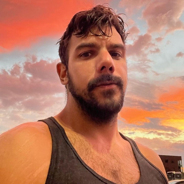 He calls himself Fossil Daddy, though prefers to keep his real identity under wraps. He is, according to his Instagram, a scientist, and describes himself as a LGBTQA+ Fossil Hunter & Fossil Pokémon Champion, Paleontological Father Figure, Twitch Affiliate/New YouTuber, and Educational thirst traps. "The queer content creator has nearly 130,000 followers across Instagram and TikTok thanks to his cheeky photos and videos that show him hunting for ancient fossils and clapping back at online trolls in his thick Boston accent," reports the Daily Mail. In an interview with the HuffPost, the hunky paleontologist posts his educational social media posts with a difference: "They're usually accompanied by his sculpted arms and hairy, tattooed chest." But, as he explains, "I get this comment pretty frequently, not verbatim," Daddy says. "'The thirst traps brought me in, but the education kept me here.'" Fossil Daddy spends days at a time uncovering ancient fossils that tell the story of how non-human life evolved on Earth. After the trips, and sometimes during, he posts about his findings, the HuffPost writes. "When you split a rock down the middle and you find a fossil, you are the first pair of eyes to ever see this animal — or plant, or whatever it may be — in hundreds of millions of years," Daddy says. "And that never ceases to blow my mind." But he admits to getting pushback from creationists, which he handles in a frank manner. "They're definitely very threatened by my presence, so maybe I should turn up the TikToks a little bit more," he tells the HuffPost. But it took him time to reach that level of confidence. Once he did, he trolled back, debunking them point-by-point. "If you really, truly believe this, then you're not that bright," Daddy says in one video reply to a creationist.⁠
⁠
Tap link in bio for more on @EDGEmedianetwork⁠
????⁠
?: @fossildaddy
