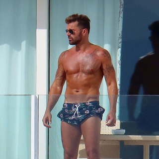 When it comes to LGBTQ+ celebrities who have transcended barriers and reached fame on a myriad of levels, Ricky Martin has to be considered one of the most influential of the last several decades. Martin entered the spotlight as part of Menudo, before he even reached adolescence. His worldwide hit "Livin' la Vida Loca" is still played on radio stations frequently over 20 years after its release, and now Martin has garnered even more fans who are interested in his family life. The artist had a long and tumultuous journey to coming out which included an awkward interview with Barbara Walters in 2000. Martin has since become more comfortable in public with his sexuality and has been married to Swedish painter Jwan Yosef since 2017. Let's look at some of the singer's most thirst-worthy Instagram posts: spending time with his husband, his children, and having fun on stage. Ricky Martin is now 51 years old, but that doesn't mean he's out of shape. Martin is very comfortable showing off what he's got, and in this post he blends in perfectly with the beautiful beach background while wearing some flattering black swimming shorts. His muscles and tattoos look just as good now as they did in his youth! ⁠
⁠
?️ Save and share this post.⁠
? Tap our link in bio to read more⁠
? @EDGEmedianetwork⁠
?: @ricky_martin
