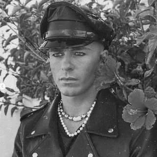 Out actor Colton Haynes gave a nod to Tom of Finland with an IG post. Dressed in a leather cap and jacket, with black-lined eyes and a pair of necklaces comprised of silver balls, Haynes looks every inch like one of the iconic gay drawings come-to-life in three posted pics. He captioned the post: "This film is not yet rated." He also included in the post "two sketches by Tom of Finland (real name Touko Laaksonen) whose homoerotic drawings shaped the fantasies of a generation of gay men before crossing over into broader cultural awareness," writes Instinct. For more on Tom of Finland, visit @tomoffinlandfoundation, which is dedicated to "protecting, preserving, and promoting the erotic arts for three and a half decades." Tap link in bio to continue on @EDGEmedianetwork ⛓️???? (?: Colton Haynes / @coltonlhaynes)