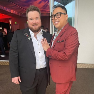 Four years after they met backstage at the 2018 GLAAD Media Awards, trans "Survivor" cast member Zeke Smith and out "Superstore" star Nico Santos came full circle: The pair got engaged onstage at this year's gala event on April 2, Us Magazine reported. Moreover, the engagement happened with the entire audience attending the event looking on, Entertainment Weekly detailed. After joining Santos onstage, Smith recalled how Santos had "got me a cocktail, lured me into his limousine, and he swept me off my feet." Then the big moment arrived, catching Santos by surprise. "Nico, your love has taught me how to love. You are my other half, and I want to spend the rest of my life with you," EW quoted Smith telling Santos, as Smith fell to one knee "during Saturday's ceremony in Los Angeles." "The 'Superstore' actor, looking stunned, said yes as Smith slipped a ring onto his finger," EW added. The couple sealed the deal with a kiss on stage, as the audience rose to its feet in a standing ovation.⁠
⁠
Congrats @zekerchief and @Nicosantos ! ???⁠
⁠
Tap link in bio to continue on @EDGEmedianetwork⁠
?️‍??????⁠
?️: Kilian Melloy / @dragelruairi ⁠
?: Zeke Smith & Nico Santos / @Nicosantos IG