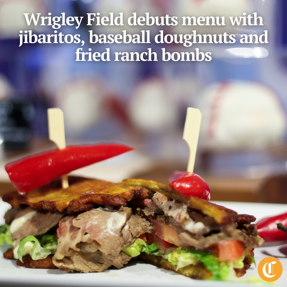 This season at Wrigley Field, hospitality group Levy and the Chicago Cubs will debut a rotating menu that pays tribute to the city and some of their baseball rivals, with new signature items including a doughnut in the shape of a baseball.⁠
⁠
When the Cubs play their first home game of the season Friday, one of the debut items will be a roast beef jibarito sandwich. The sandwich has its roots in the Chicago Puerto Rican community and was selected as a gluten-free option; instead of bread, the fillings are sandwiched between two fried plantains. Wrigley’s iteration has roast beef, garlic aioli and a sweet red pepper for garnish.⁠
⁠
“The jibarito sandwich was actually created here in Chicago,” Mary Ann Culleton, executive chef for Levy at Wrigley Field, said at a preview event Wednesday morning. “We believe we’re the only baseball park featuring that this season.”⁠
⁠
Tap on our bio link to read more.⁠
⁠
— — — ⁠
⁠
Photo 1: The Jibarito Sandwich, a gluten-free option on a plantain bun with roast beef, garlic aioli, lettuce, tomatoes and garlic butter. ⁠
⁠
Photo 2: The Ranch Bombs come with a spicy honey drizzle. ⁠
⁠
Photo 3: The Short Rib Sliders feature an 18-hour smoked beef ribs and barbecue sauce.⁠
⁠
Photo 4: Clark the Cub (left) and Mary-Ann Culleton hold the Baseball Donuts that come with a vanilla frosting as well as a choice of blueberry or strawberry jam in a pipette.⁠
⁠
Photo 5: The Puffy Taco has carne asada, lettuce, tomatoes, sour cream and cheddar in a crispy flour tortilla.⁠
⁠
Photo 6: The McCain Super Crisp Chili-Lime Fries with tajin seasoning, cotija cheese and corn crema.⁠
⁠
Photo 7: Featured drinks that will be available at Marquee Classics in Section 117.⁠
⁠
? Ahmed Ali Akbar / Chicago Tribune⁠
?️ Audrey Richardson / Chicago Tribune