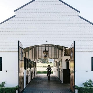 For accomplished dressage rider Meaghan Willis, building a Dutch-style stable for her beloved warmbloods Harry and Romeo, was a dream come true. Take a tour of her beautiful formal garden (which overlooks Hanging Rock in the Macedon Ranges) by clicking the link in bio. ⠀
.⠀
 #gardendesign⠀
#horsebarn⠀
#horsesofinstagram⠀
.⠀
Words: @virginia_imhoff⠀
Photo: @marniehawson