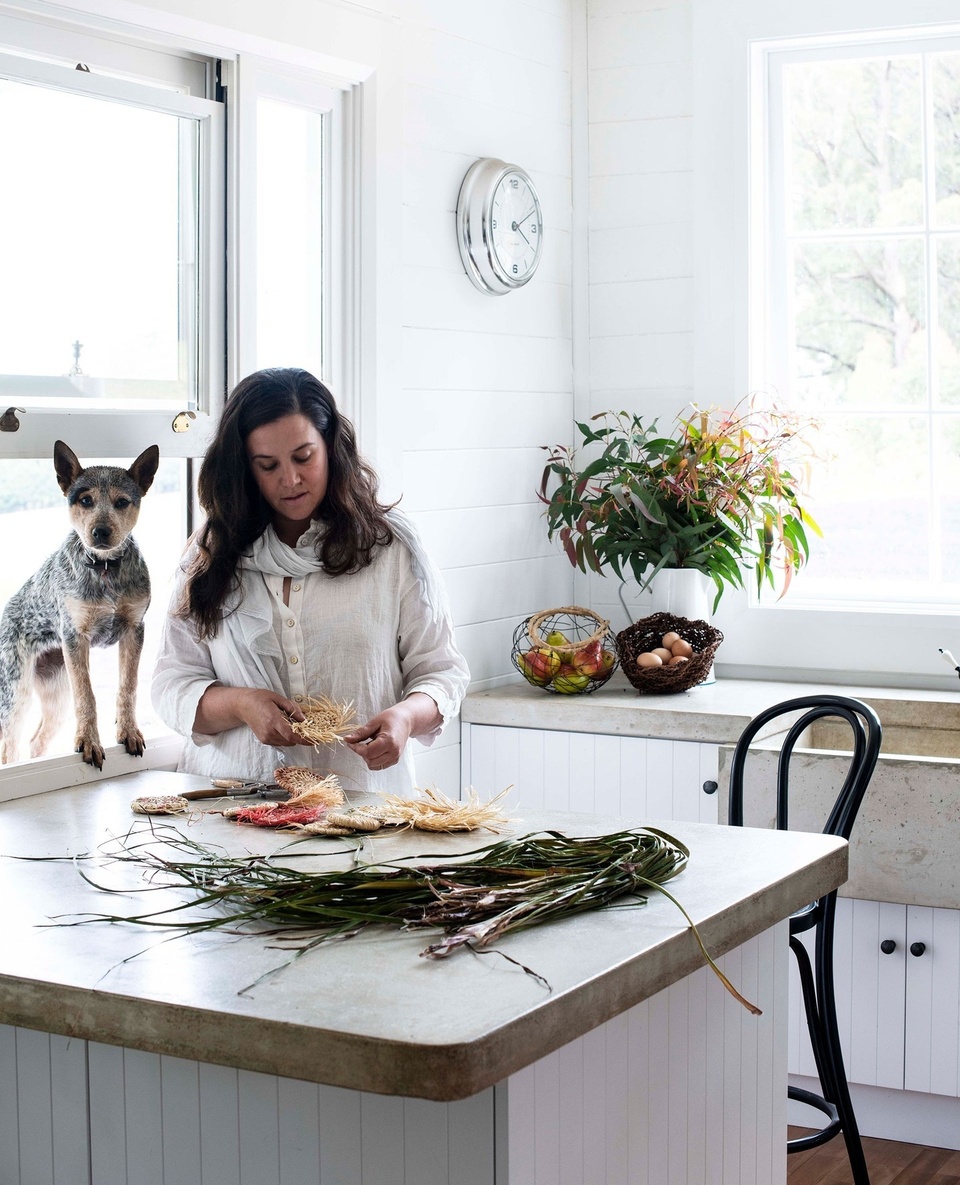 At Christmas time, Brooke and Colin Munro decorate their storybook pretty home with handmade creations woven from raffia. Here, Peggy the cattle dog watches intently as Brooke works her weaving magic. ⁠
⁠
Before renovations, however, their 1970s farmhouse was in a state of disrepair. But the pair channelled their efforts into rebuilding the floors, ceiling, roof and re-cladding upstairs and downstairs. ⁠
⁠
Tap the link in our profile to see what the home looks like today. ⁠
⁠
Photography: @brigidarnottphotography⁠
Styling: Hannah Brady⁠
Words: @alexspeedjournalist⁠
⁠
#whitekitchen #christmasdecorating #concretebench #farmhousekitchen #renovation⁠
