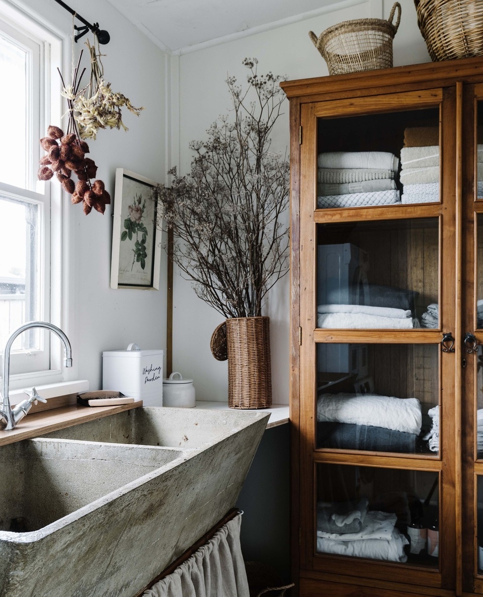 The laundry is one of the hardest-working rooms in the house. But that doesn't mean it can't be stylish! ⁠
⁠
At Moonliters Cottage in Anglesea, VIC, owner Gemma Grange embraced a vintage look. An old concrete sink sourced from a local cafe takes pride of place, wrapped in a linen skirt sewn by her mum.⁠
⁠
For more inspiring laundry ideas, tap the link in our profile. ⁠
⁠
Photography: @marniehawson⁠
⁠
#laundrydecor #laundrystorage #laundryrenovation #cottagelaundry #cottagestyle