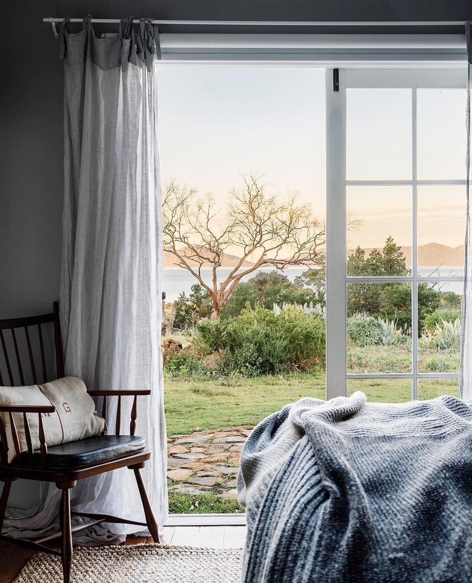 Gentle waves, sheer curtains blowing on a sea breeze and craggy coast-meets-bush views are the norm at The Burrows in Swansea.⁠
⁠
Inviting disconnect and relaxation, the restored holiday cottage was originally intended as a bolthole for owners Bek Burrows and Paul DeRuyter. "The beds are sumptuous, but the doors are old, the laundry has a concrete floor, and there's no dishwasher," says Bek. "It's not about living with the latest appliance or technology." ⁠
⁠
Step inside via the link in bio.⁠
⁠
Photography: @adam.gibson.photo @abbie_melle⁠
Styling: @bellebrightproject @lynda.gardener⁠
Words: @hilaryburden⁠
⁠
#tasmania #cottage #coastalcottage #holidayhome #weatherboardhome