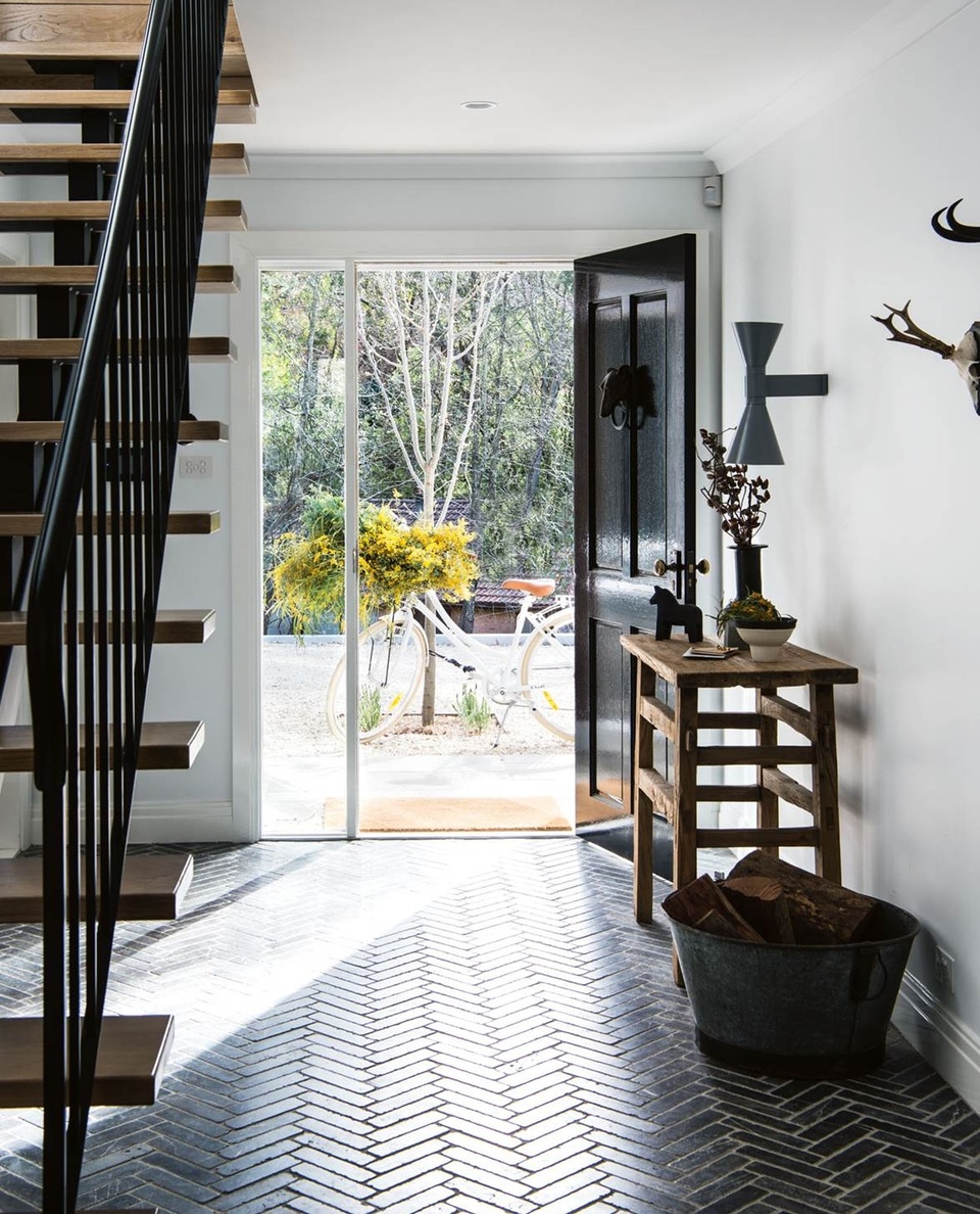 The NSW #BlueMountains holds many precious childhood memories for Kasturi and Simon Wren, who decided to build their dream home surrounded by the rambling wilderness of small town Leura.⁠
⁠
While the home itself is modern, a classic monochrome palette combined with #rustic furniture and charming details, like this herringbone floor in the #entryway, instil character and warmth.⁠
⁠
Tap the link in our bio to take a tour. ⁠
⁠
Photography: @brigidarnottphotography / Styling: @johnmangila⁠
⁠
⁠
