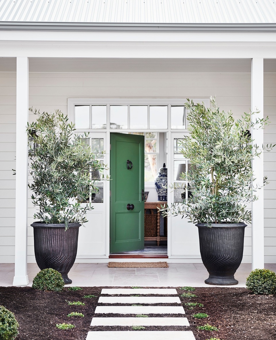 In the rolling hills of the Macedon Ranges in Central Victoria sits The Overflow; a modern farmhouse shaded by wide verandahs and sitting upon 111 hectares of land.⁠
⁠
It took six years and lots of careful planning and execution for the family of five to create what they had dreamed of. "We feel a lot of freedom here and we don't feel obligated to get out the door and down to the park every day; we can hang out at home," Clare says. ⁠
⁠
Photography: @lisacohenphoto⁠
Styling: @tess.newman.morris⁠
Words: @ginimhoff⁠
⁠
#greendoor #olivetrees #weatherboardhome #whiteweatherboard #farmhouse