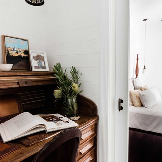 An antique roll-top desk decorated with flowers and paintings contrasts with crisp white walls, and is perfectly in keeping with the "south-east Asia meets coastal house" feel of Vicki and Tony Lemarseny's Peregian Beach home. ⁠
⁠
Tap the link in our bio for more home office inspiration.⁠
⁠
Photography: @hannahpuechmarin⁠
Styling: Cheryl Carr @albertandgrace⁠
⁠
#homeoffice #homeofficeideas #desksetup #desk⁠
