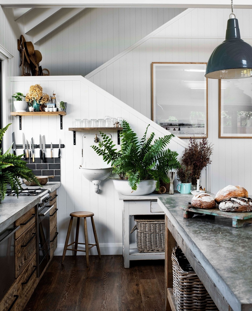Despite being a new build, there's nothing sterile or lacking in personality about this modern barn-style home on Lake Conjola.⁠
⁠
In the kitchen, salvaged timber drawer fronts, salvaged old factory pendants, and a concrete bench poured on-site add the kind of warmth only a rustic, country style home can possess. "I love working with textures and neutral colours. Straw, timber, concrete: they're my favourites," says Leah Atkins, who built this home alongside her husband. "I like to create little vignettes, to make a home feel like home."⁠
⁠
Take a tour via the link in bio.⁠
⁠
Photography: @brigidarnottphotography⁠
Styling: @hannah.brady⁠
Words: @becwhish⁠
⁠
#timberkitchen #countrykitchen #concretebench #kitchenpendants