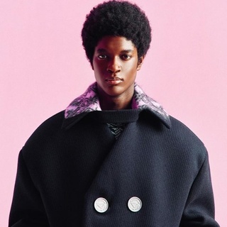 Milan's fall/winter 2021 menswear shows have gone digital this week, catapulting creative directors like Prada's Miuccia Prada and Raf Simons into filmmakers as much as designers. The designers took comfort to an entirely new level, reimagining onesies in luxe fabrics, deconstructing suiting elements, and embracing both textural elements and button details in outerwear. Discovering Prada's triangle logo became a game of "Where's Waldo?" with the signature branding appearing on buttons, gloves and clothing accents. "The moment of a creative renaissance is very far," said Prada, as reported by Business of Fashion. "We have a very important sense of responsibility for the moment." "It's not right to be exuberant," Simons added. "The bodysuit represents the body, but other pieces are minimalized. We wanted a calmness in shape." The 11-minute fashion show features music by one of Simons' favorite techno musicians, Plastikman, aka Ritchie Hawtin. Tap link in bio to continue on @EDGEmedianetwork ?????⁠
⁠
?️: Matthew Wexler / @wexlerwrites⁠
?: Prada / Instagram