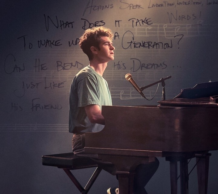 Lin-Manuel Miranda directs the film adaptation of Jonathan Larson's play "tick, tick... BOOM!," bringing an authenticity to the experience of creating a musical — the fear, the frustration, and the overriding optimism that Miranda (the force behind "Hamilton" and co-creator of "In the Heights") must know well.⁠
⁠
"tick, tick... BOOM!" tells the story of Larson's struggle to put together a presentation of a science fiction musical he calls "Superbia." Set in a toxic future, it's about how people spend all their time fixed on their "media delivery devices," and patterning their lives after TV programs. (All in all, Larson more or less hit the nail on the head.) The problem is that no one understands what he's going for, and no one thinks the show is going to succeed. Larson (played by British actor Andrew Garfield) swims recreationally, for exercise and to clear his head, but he's swimming upstream when it comes to getting anyone to pay attention to his idea. ⁠
⁠
The movie is well written (by Steven Levenson, based on Larson's play) and competently directed by Miranda, who displays some impressive visual inventiveness. It also often feels, however, like the reverse side of a tapestry or, in more mundane terms, a sort of "Behind the Music" look at Larson's pre-"RENT" life and struggles. The songs underscore the impression; they are uniformly energetic, and there are a couple of gorgeous numbers that break the mold, but most of the setlist feels prototypical of, and cut from the same cloth, as the songs from Larson's bigger, better-known work.⁠
⁠
If you're still high on Jon M. Chu's movie version of "In the Heights" (and excited for his next musical adaptation, "Wicked"), and chomping at the bit to see what Steven Spielberg is going to do with "West Side Story," this is the perfect movie at the perfect time to keep your feet tapping and your "Broadway by way of Hollywood" buzz going strong.⁠
⁠
Tap link in bio to continue on @EDGEmedianetwork ??❤️⁠
⁠
?️: Kilian Melloy / @dragelruairi ⁠
?: Netflix
