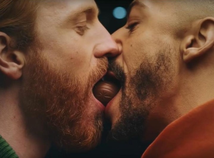 It's no great surprise that haters took aim at the recent LGBTQ-inclusive ad for Cadbury's creme eggs, but one of the models in the ad's "sticky same-sex kiss" isn't putting up with what he notes is a double standard. The ad features models Callum Sterling and Dale Moran sharing a Cadbury's creme egg in mouth-to-mouth "Lady and the Tramp" style. The ad has prompted "homophobic trolling on social media," reports Ad Age. Sharing a post from another user at Instagram that calls out the fuss made by those who decry the ad while ignoring the nonstop barrage of (hetero) sexualized images that consumers are subjected to every day, Sterling points out that far fewer people would complain about an identical ad casting "two 'beautiful' cisgendered hetero-looking Caucasian women. So it's ok when an advert sexualizes a women, a caucasian women, THIRTY SEVEN years ago even, to benefit the male gaze and make other women feel inadequate if they do not live up to this beauty standard," Sterling wrote, referencing a lipstick ad from 1984 that featured Lynda Carter. The vintage ad was contained in the post he was sharing. "But it's not okay, in 2021, to have an advert of a multi racial (strike one) gay couple (strike two) on your screens for 10 seconds (strike three) eating/kissing/sexualised (strike four)," Sterling continued, going on to add, "does anyone see how ridiculous this is? Like actual LOL." Tap link in bio to continue on @EDGEmedianetwork ?️‍???⁠
⁠
?: Cadbury / YouTube⁠
?️: Kilian Melloy / @dragelruairi 
