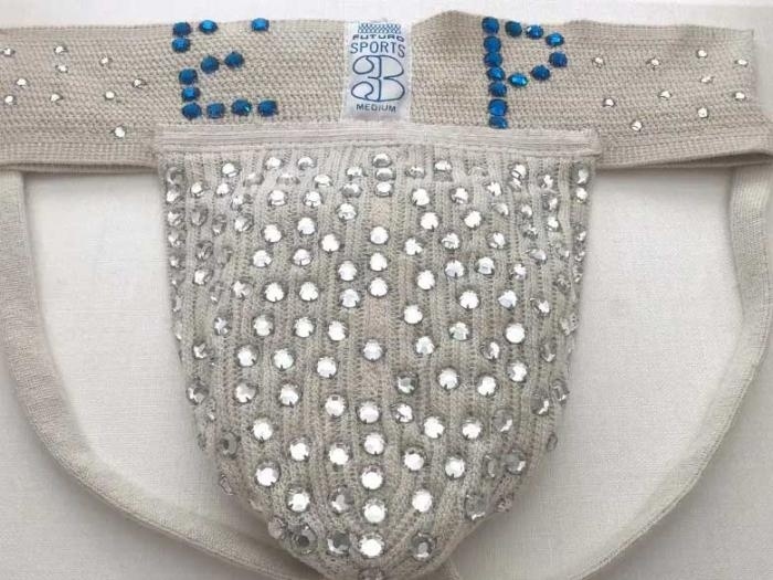 Do you want to wear the King's jockstrap? Finishing in a tie with "Top Gun: Maverick" over the weekend, Baz Luhrmann's "Elvis" appears to be a hit, though the opening weekend gross ($30M) was below other biopics like "Bohemian Rhapsody" ($51M) when it came out. The final gross report will reveal if the pic (which cost some $85M) will be the No. 1 film of the week. Likely due to the renewed attention toward Presley, who died in 1977 at the age of 42 from a heart attack, an item from his wardrobe is finding its way to auction: his bejeweled jockstrap, showing that he was bedazzled right down to his crotch. The jock — from the brand Futuro Sports — is white with blue diamonelles on either side of the label spelling his initials ("EP") with some 20 silver rhinestones on either side. But what really makes the jock distinctive are the 100+ silver rhinestones attached to the support pouch. According to the New York Post, the strap was made by a fan and worn by Presley for years until his 1977 death. The Post added that the bedazzled jock "is expected to fetch $36,000 when it goes on the block as part of the Elvis Presley Museum collection being sold by Paul Fraser Collectables." "[It's] Extravagant. Absurd. Sexually potent. This rhinestone-studded jockstrap is pure Elvis Presley. I'm sure the new owner won't be able to resist wearing it out on a Saturday night — the Elvis magic will work wonders, I'm certain. This is a rare opportunity to own an intimate piece of the King, " Paul Fraser Collectibles' Daniel Wade said, according to the Daily Mail.⁠
⁠
Tap link in bio to continue on @EDGEmedianetwork⁠
????⁠
?: Paul Fraser Collectibles