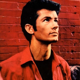 In the opening sequence in "West Side Story," there is an iconic image of George Chakiris. In a close-up, he stands with one hand pressed against a red brick wall brooding with anger after being harassed by members of a rival teen gang, the Jets. Stepping away, he begins to snap his fingers joined by two other Sharks. Then to surging Leonard Bernstein music, the three break into dance, first on a street than framed against the tenements of New York's West Side that were razed after the filming was completed. In this moment, the smoldering Chakiris establishes a formidable presence in this musical retelling of "Romeo and Juliet" set amongst infighting between juvenile gangs in New York. Hollywood agreed, awarding him (along with co-star Rita Moreno) a supporting performance Oscar. Up to that point, Chakiris had been in numerous films, but largely in small roles, usually as a dancer or chorus member in such films as "The Great Caruso," "Stars and Stripes Forever," "Call Me Madam," and "The 5,000 Fingers of Dr. T." He is famously seen in 1951's "Gentlemen Prefer Blondes" as one of the men with Marilyn Monroe in the "Diamonds are a Girl's Best Friend" number. And in 1953 opposite Rosemary Clooney in "White Christmas" performing "Love, You Didn't Do Right by Me." A publicity photo from that scene generated so much fan mail to Paramount that the studio offered him a contract; but unhappy with his career, he moved to New York City in the late 1950s to pursue a stage career. After being cast as Riff in the London production of "West Side Story," he was flown to Hollywood to audition for either that role or his rival Bernardo for the film version, and worked with the show's creator Jerome Robbins for his audition. This led to him being cast in the film, overnight stardom and an Oscar. Then in November of 2012, he had the honor of placing his hand and footprints in cement at Grauman's Chinese Theatre in honor of the film's 50th anniversary. EDGE spoke to Chakiris about "My West Side Story: A Memoir." Tap link in bio to continue on @EDGEmedianetwork ?? (?️: Steve Duffy, ?: George Chakiris / West Side Story / MGM)