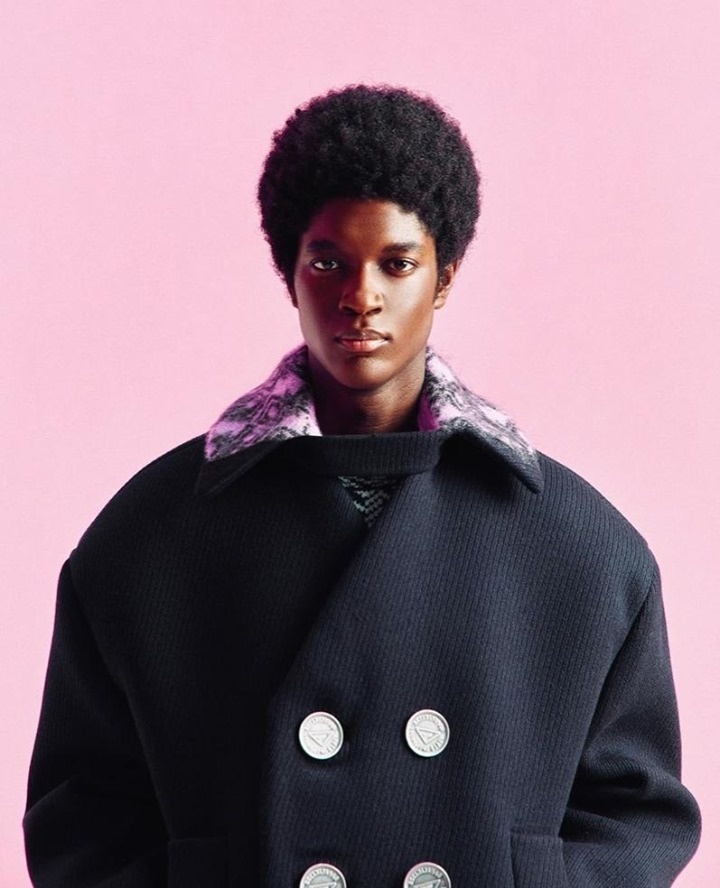 Milan's fall/winter 2021 menswear shows have gone digital this week, catapulting creative directors like Prada's Miuccia Prada and Raf Simons into filmmakers as much as designers. The designers took comfort to an entirely new level, reimagining onesies in luxe fabrics, deconstructing suiting elements, and embracing both textural elements and button details in outerwear. Discovering Prada's triangle logo became a game of "Where's Waldo?" with the signature branding appearing on buttons, gloves and clothing accents. "The moment of a creative renaissance is very far," said Prada, as reported by Business of Fashion. "We have a very important sense of responsibility for the moment." "It's not right to be exuberant," Simons added. "The bodysuit represents the body, but other pieces are minimalized. We wanted a calmness in shape." The 11-minute fashion show features music by one of Simons' favorite techno musicians, Plastikman, aka Ritchie Hawtin. Tap link in bio to continue on @EDGEmedianetwork ?????⁠
⁠
?️: Matthew Wexler / @wexlerwrites⁠
?: Prada / Instagram