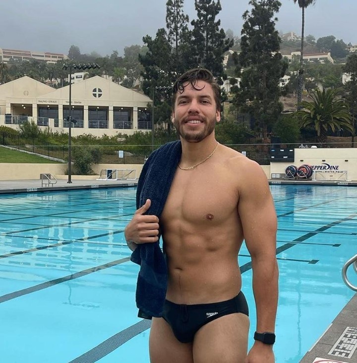Arnold Schwarzenegger's son Joseph Baena, showed that he's looking more and more like his famous bodybuilder dad with his latest thirst-trap. Baena spent time at the pool of his alma mater, Pepperdine University, where he did a few laps in the rainy Malibu weather while wearing a black speedo, reported the Daily Mail. He wrote in his post: "Rainy days in LA are surprisingly refreshing. Started the day off with a swim and now heading to my next listing appointment. Hope every has a great hump day!!!" Earlier this month he posted a pic of himself with his dad that showed their strong resemblance. "Happy Birthday Dad! I hope your pump was juicy and may your day be filled with lots of schnitzel, schnapps and stogies!!!," he wrote in the post. Father and son have worked out together over the past year, which Baena has chronicled on IG. "This selfie was taken moments before my dad suggested I do "forced reps" for the rest of the workout. You have to go all out and absolutely NO cheating when you train with him, so you know I'm going to be hurting tomorrow," he wrote. Tap link in bio to continue on @EDGEmedianetwork ???? (?: Joseph Baena / Instagram)